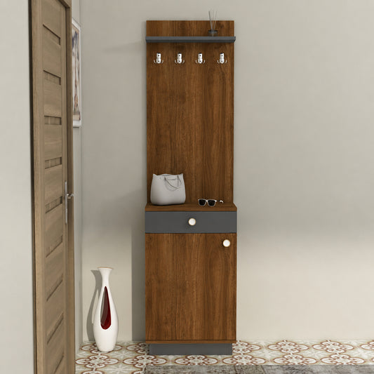 A tall wooden entryway cabinet with a warm brown finish and gray drawer/front panels, shown in a room corner. The cabinet has five metal hooks on the top panel, a small shelf with a white handbag and sunglasses, a lower cabinet door, and decorative knobs.
