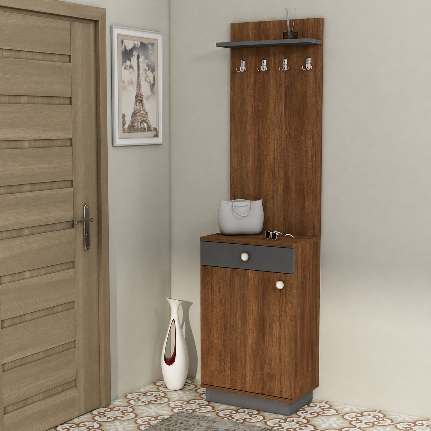 A tall brown wood entryway cabinet with a top shelf, four hanging hooks, a lower drawer, and a small side table surface, shown in a room next to a door with a framed picture and a vase.