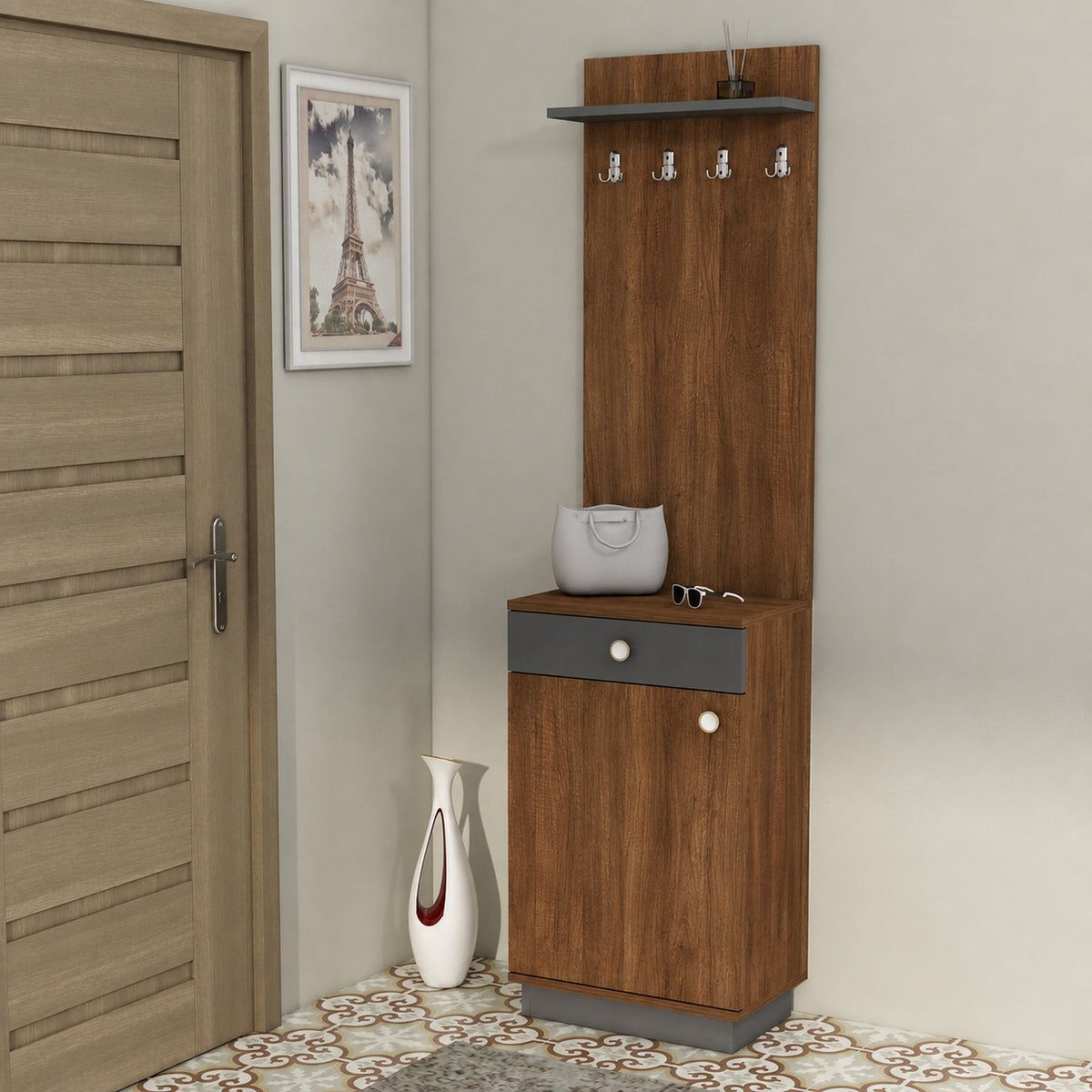 A tall brown wood entryway cabinet with a top shelf, four hanging hooks, a lower drawer, and a small side table surface, shown in a room next to a door with a framed picture and a vase.
