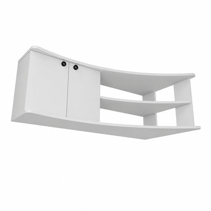 A modern white curved wall-mounted media console with two cabinet doors on the left, featuring small black round knobs, and three open shelves on the right, shown against a plain white background.